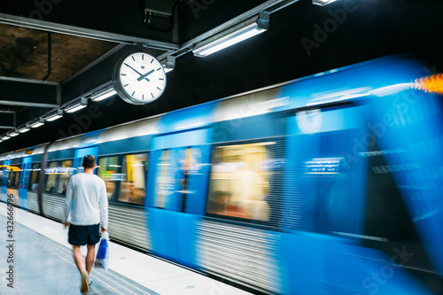 Stockholm, Sweden. Modern Illuminated Metro Underground Subway Station In Blue And Gray Colors With Moving Train photo