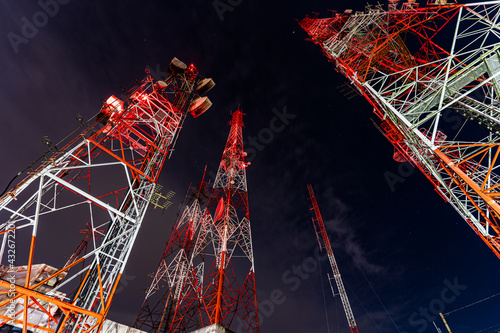 Tower of communication with antennas at night time.