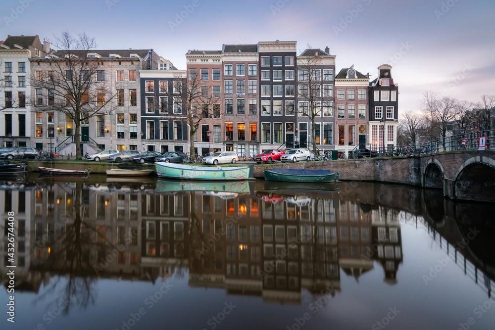 Historic canal houses along the Keizersgracht canal in Amsterdam on a quiet winter evening.