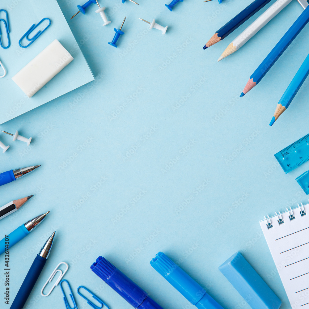 Frame of white and blue school supplies on an bright blue background. Concept back to school. School or stationery shop spring summer sea concept. Copy space, flat lay, top view, background. Frame of white and blue school supplies on an bright blue background. Concept back to school. School or stationery shop spring summer sea concept. Copy space, flat lay, top view, background.