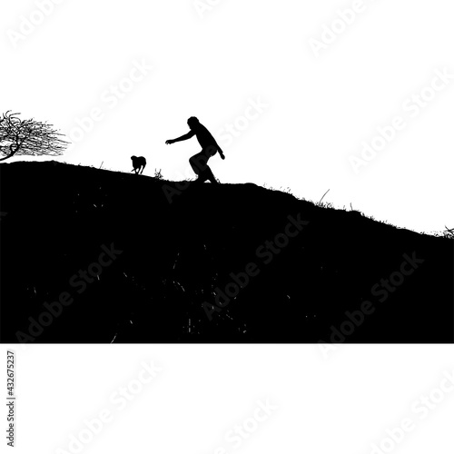 silhouette of a person playing with a dog on a cliff