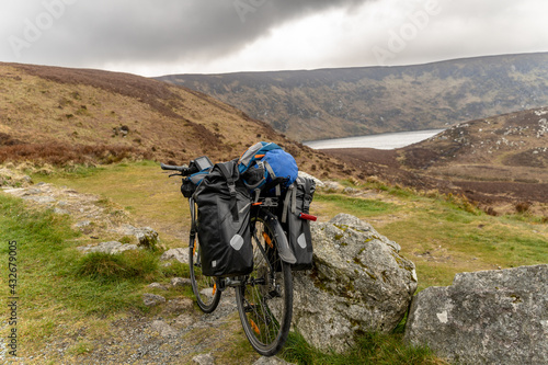 a Bike packer bike resting on mountainous landscape