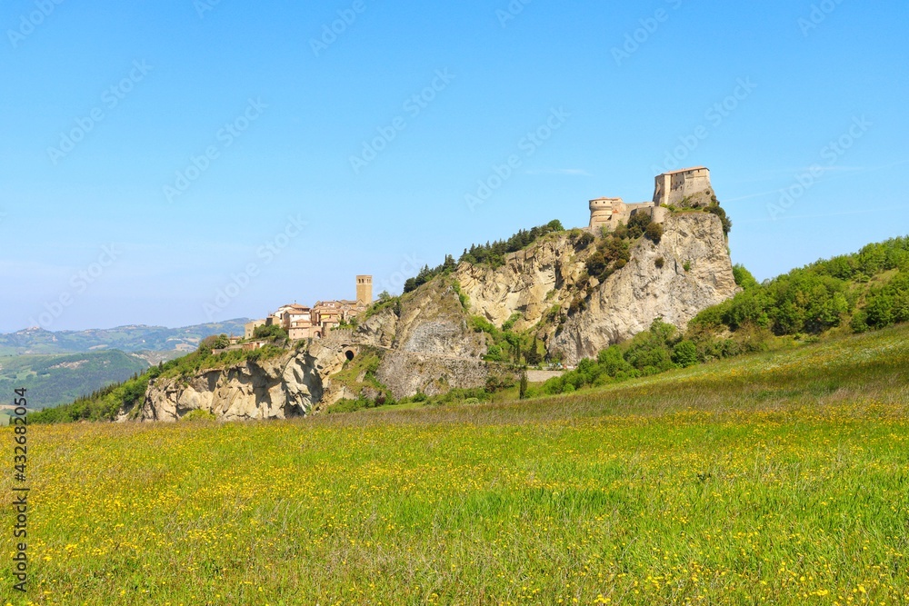 Beautiful landscape view of small old town on the hill against blue sky during spring in San Leo,Province of Rimini,Italy