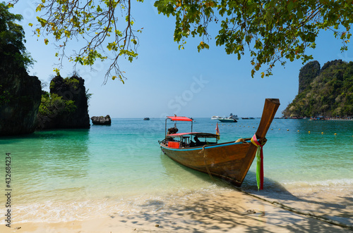 landscape of long tail boat riding on the blue sea of largoon of Koh Hong, Krabi, Thailand in summer © plo