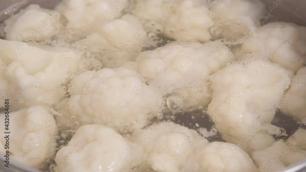 Cauliflower cooked in hot water close-up. Cooking vegan food concept. Cauliflower cooked in hot water close-up. Cooking vegan food concept.