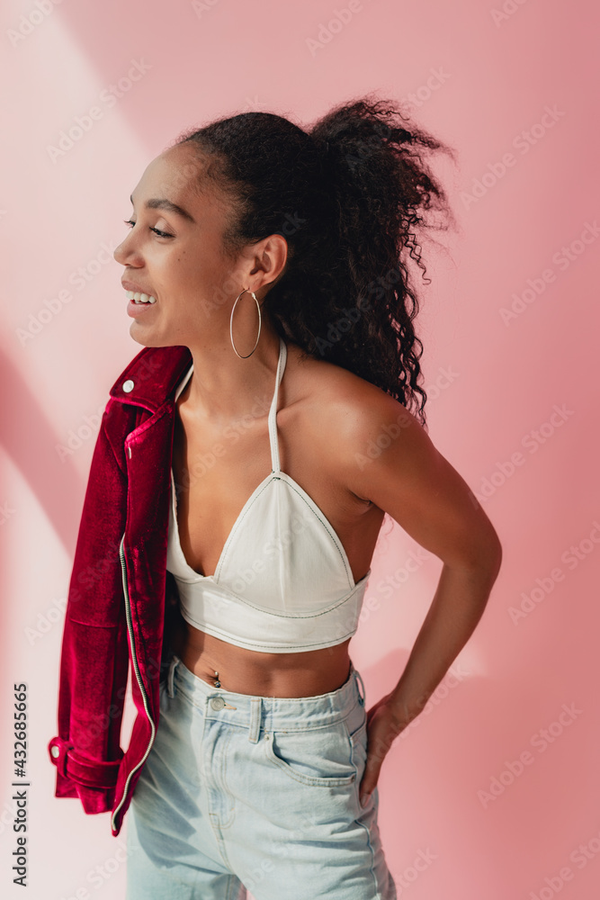 attractive black african american woman in stylish outfit on pink background attractive black african american woman in stylish outfit on pink background