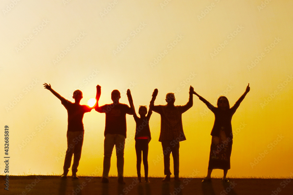 Three generation family standing with raised hands Three generation family standing with raised hands