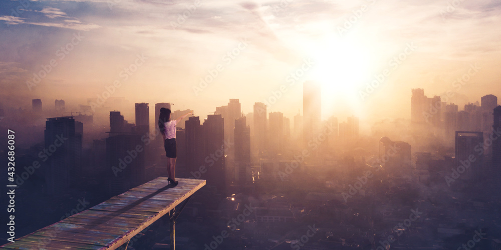 Businesswoman pointing at silhouette of cityscape
