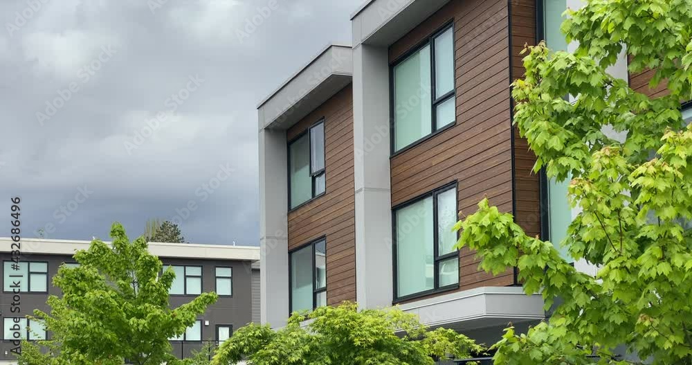 Establishing shot of modern apartment building with stairs and beautiful landscape in Vancouver, Canada, North America. Night time on May 2021. Still camera view. ProRes 422 HQ. Establishing shot of modern apartment building with stairs and beautiful landscape in Vancouver, Canada, North America. Night time on May 2021. Still camera view. ProRes 422 HQ.