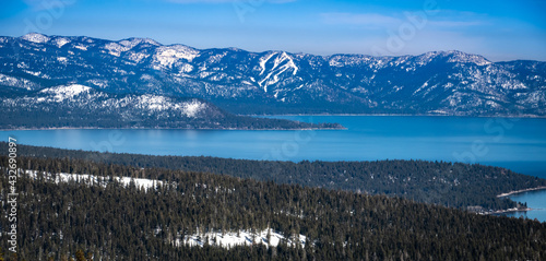 Scenic view of Lake Tahoe, in the Sierra Nevada Mountain Range of California, as shot from Alpine Meadows, with the runs Diamond Peak ski resort in the background. 