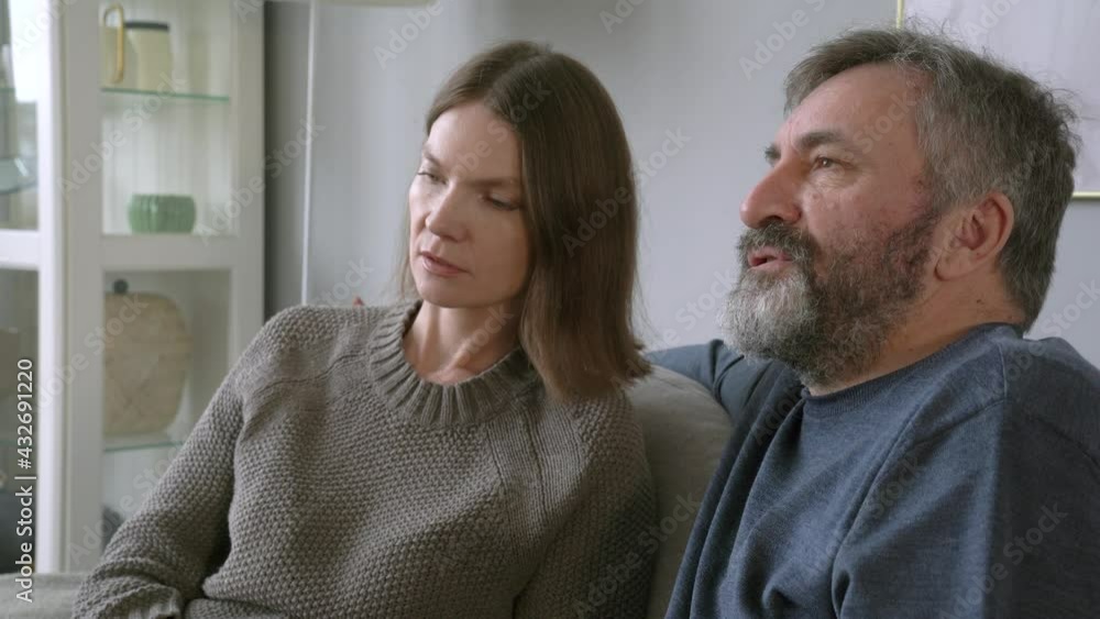 Close Up of Middle Age Man With His Wife. Smiling Beautiful Woman Teaching Husband To Buy Online Close Up of Middle Age Man With His Wife. Smiling Beautiful Woman Teaching Husband To Buy Online