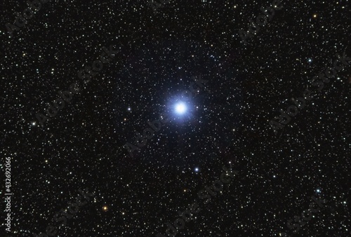 Vega, the brightest star in the Lyra constellation, 25 light years from Earth. Backgrounds night sky with stars with 80 mm refracting telescope photo