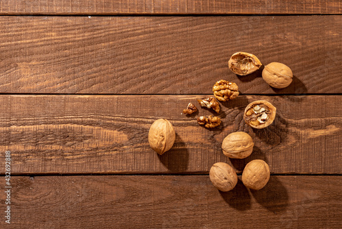 Walnuts on the wooden background