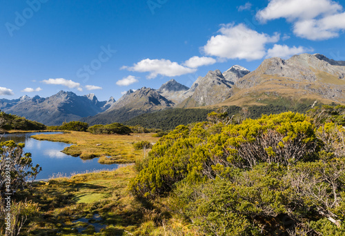 alpine lake at Key Summit Track in Fiordland National Park, South Island, New Zealand with blue sky and copy space © Patrik Stedrak