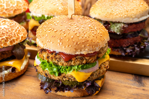 Tasty vegetarian cheeseburgers and hamburgers with round patties or burgers made from grains, vegetables and legumes