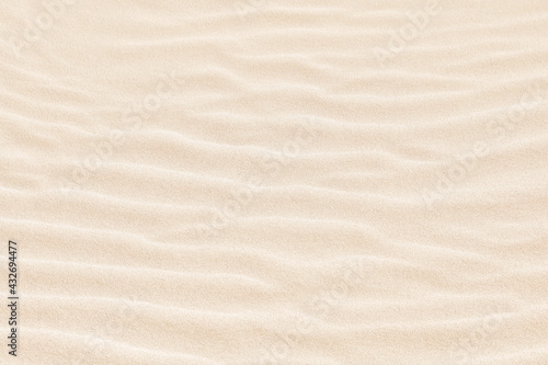 Abstract irregular pattern in white sand on beach. Textured summer background.