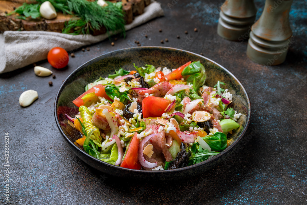 Salad with roast beef and vegetables on dark concrete table Salad with roast beef and vegetables on dark concrete table