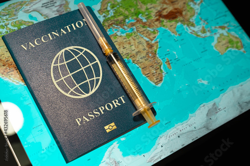 International vaccination Passport with syringe on the background of world map. Travel concept during the Covid-19 pandemic. vaccination vaccine passport or certificate for travelers. photo