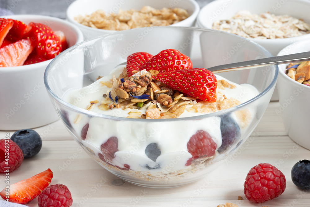 granola, cereals and berries, various delicious ingredients for breakfast in a glass bowl granola, cereals and berries, various delicious ingredients for breakfast in a glass bowl