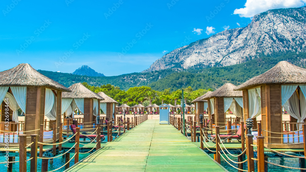 Fototapeta premium Wooden beach pavilions on the shore of a sandy beach