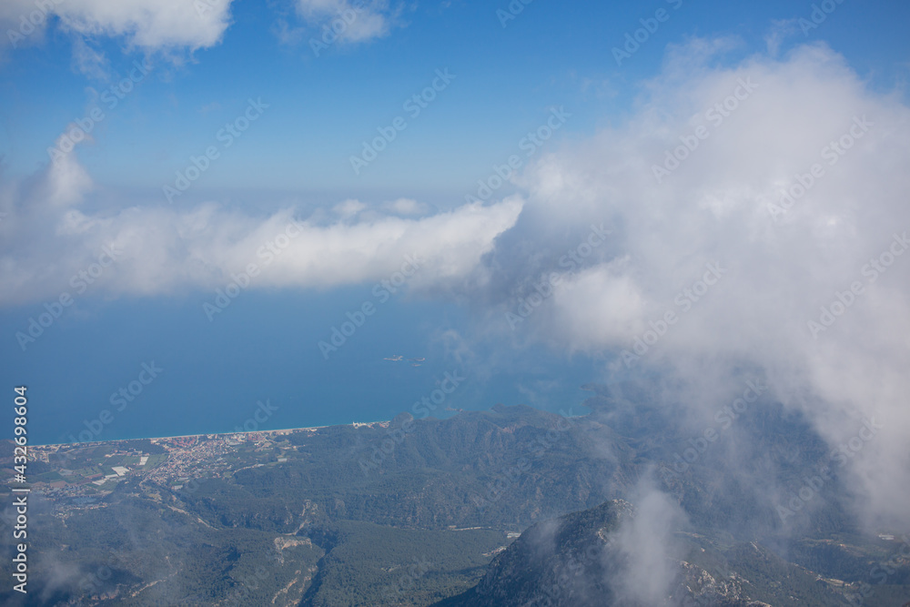 Mediterranean sea and cost view from the mountain summit through clouds