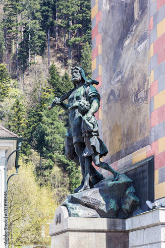 Statue of William Tell and his son at the Rathausplatz (City Hall Square) of Altdorf, Switzerland. Wilhelm Tell, the folk hero of Switzerland. The statue was built in 1895. photo