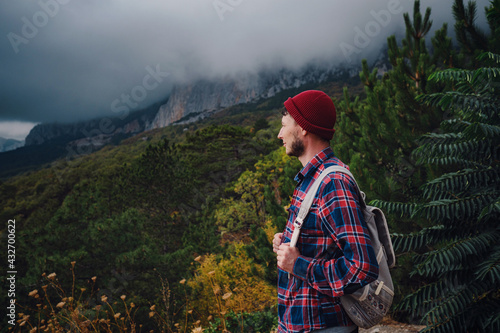 Man traveling with a backpack hiking in the mountains travel. © YURII Seleznov
