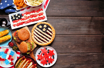 Fourth of July, patriotic, American themed food. Top view side border on a dark wood background. Copy space.