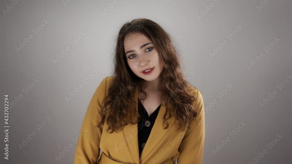 Smiling woman becomes suddenly unhappy and crosses hands after what she returns in positive mood in slow motion on white background. Concept of changing emotions and mental health. Theme of psychology Smiling woman becomes suddenly unhappy and crosses hands after what she returns in positive mood in slow motion on white background. Concept of changing emotions and mental health. Theme of psychology