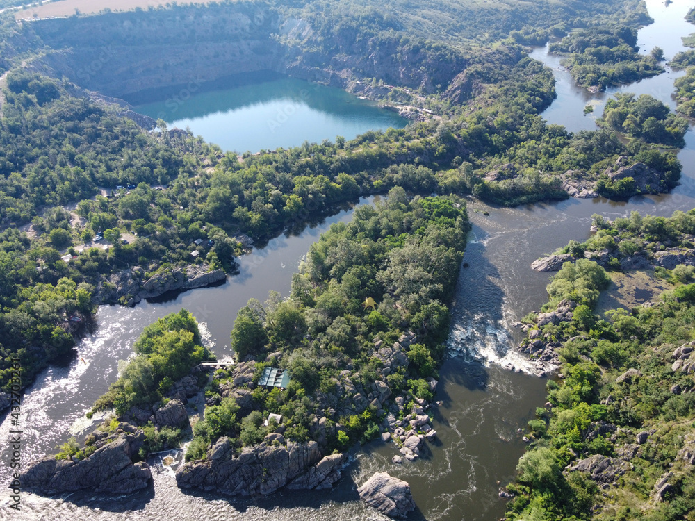 Radon lake near the Southern Bug river on a sunny summer day. Picturesque landscape from a bird's eye view. Flooded granite quarry.