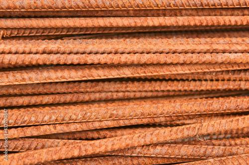 background - rusty reinforcing bars piled in a heap close-up