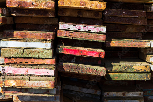A close up on a pile of scaffold boards ends