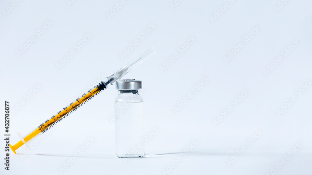 The vaccines vials glass bottle and disposable syringe on white The vaccines vials glass bottle and disposable syringe on white