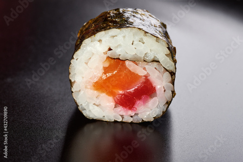 sushi with salmon and rice one piece close-up black background