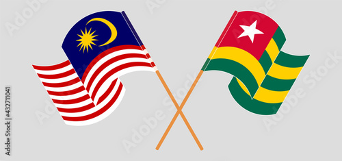 Crossed and waving flags of Malaysia and Togo