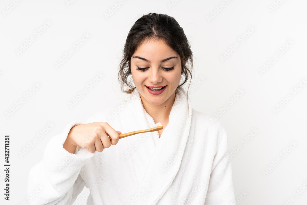 Young caucasian woman isolated on white background with a toothbrush