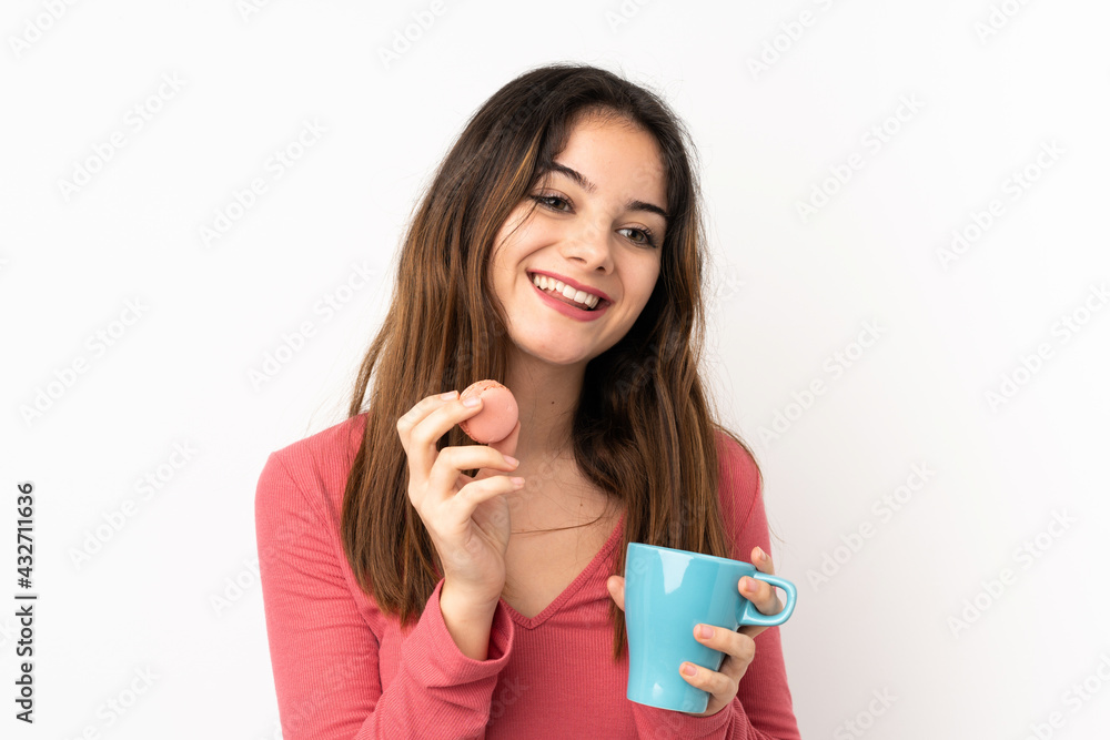 Young caucasian woman isolated on pink background holding colorful French macarons and a cup of milk Young caucasian woman isolated on pink background holding colorful French macarons and a cup of milk