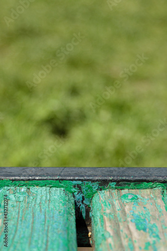 A fragment of an old shabby park bench.
