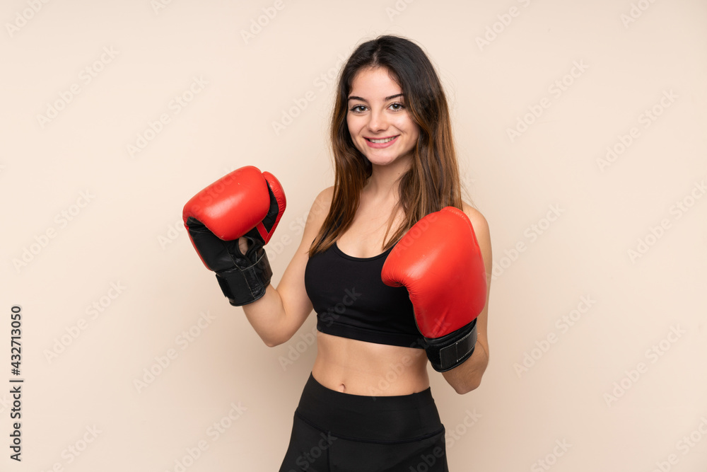 Young sport woman with boxing gloves over isolated background