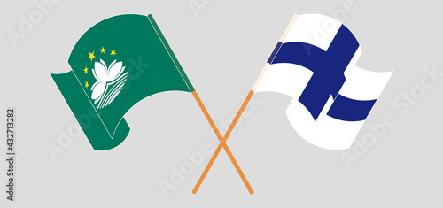 Crossed and waving flags of Macau and Finland