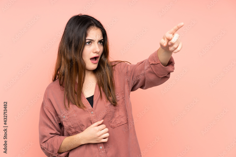 Young caucasian woman isolated on pink background pointing away Young caucasian woman isolated on pink background pointing away