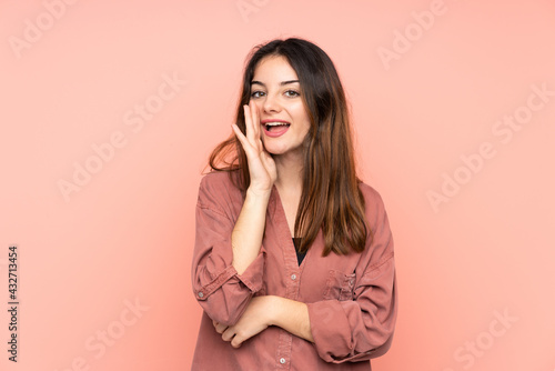 Young caucasian woman isolated on pink background shouting with mouth wide open