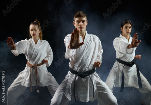 Female karate fighters, training with master