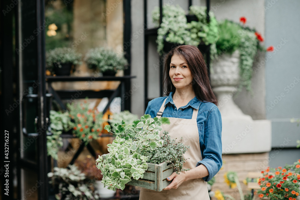 Positive emotions, successful small business and owner of floral shop outdoor