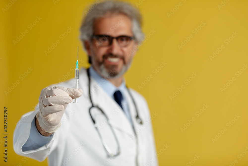 Close up photo of syringe with vaccine in doctor's hand. Close up photo of syringe with vaccine in doctor's hand.