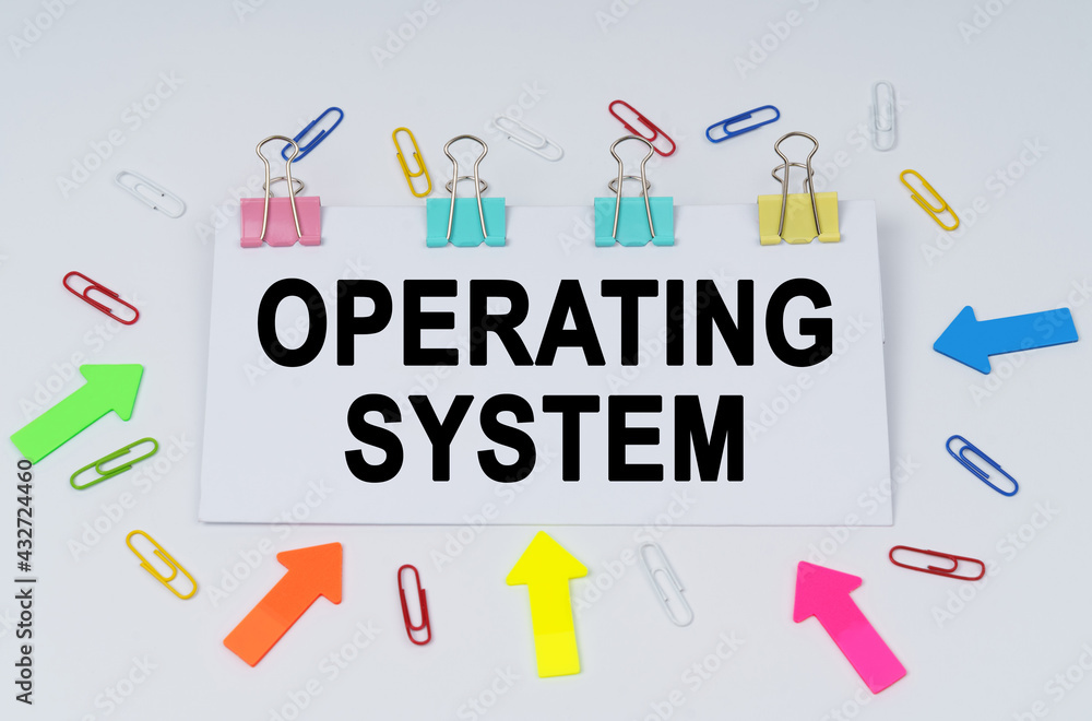 On the table there are paper clips and directional arrows, a sign that says - OPERATING SYSTEM On the table there are paper clips and directional arrows, a sign that says - OPERATING SYSTEM