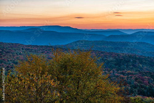 Fototapeta Naklejka Na Ścianę i Meble -  West Virginia Monongahela national forest overlook with colorful orange yellow clouds above mountains horizon in autumn with colorful tree foliage at morning sunrise in Highland Scenic Highway