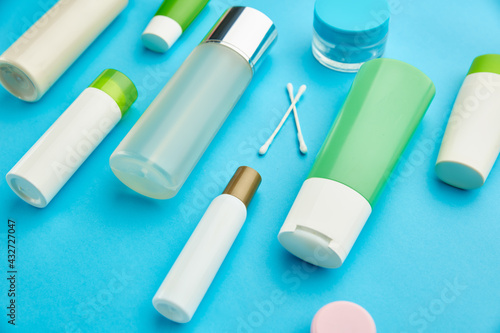 Care products on blue background, nobody