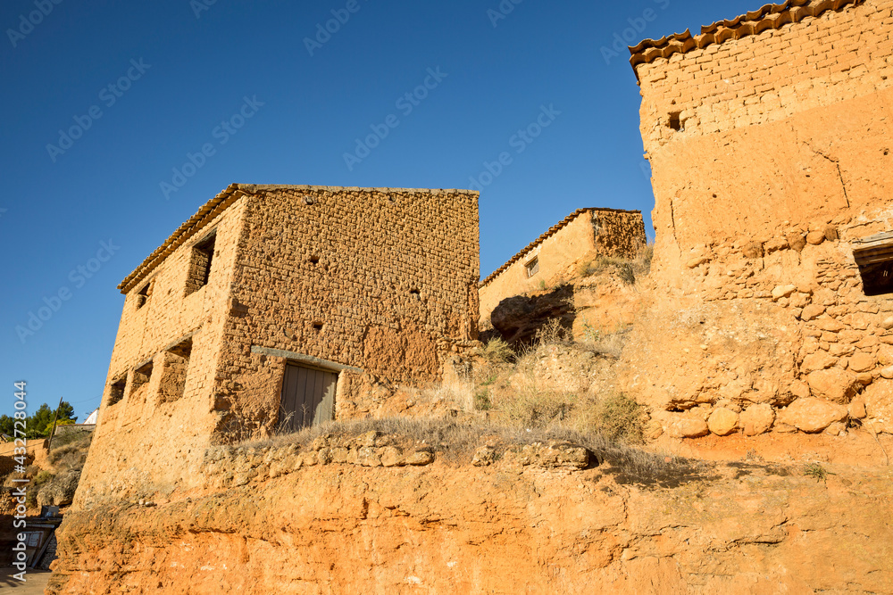 a street with old houses made of clay in the suburb of Arcos de Jalon, province of Soria, Castile and Leon, Spain