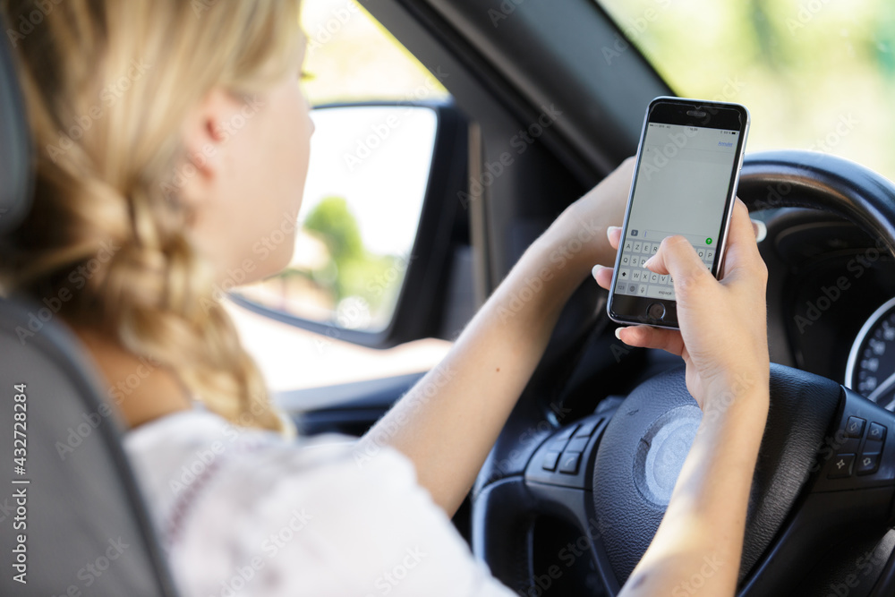 woman using her cellphone while driving